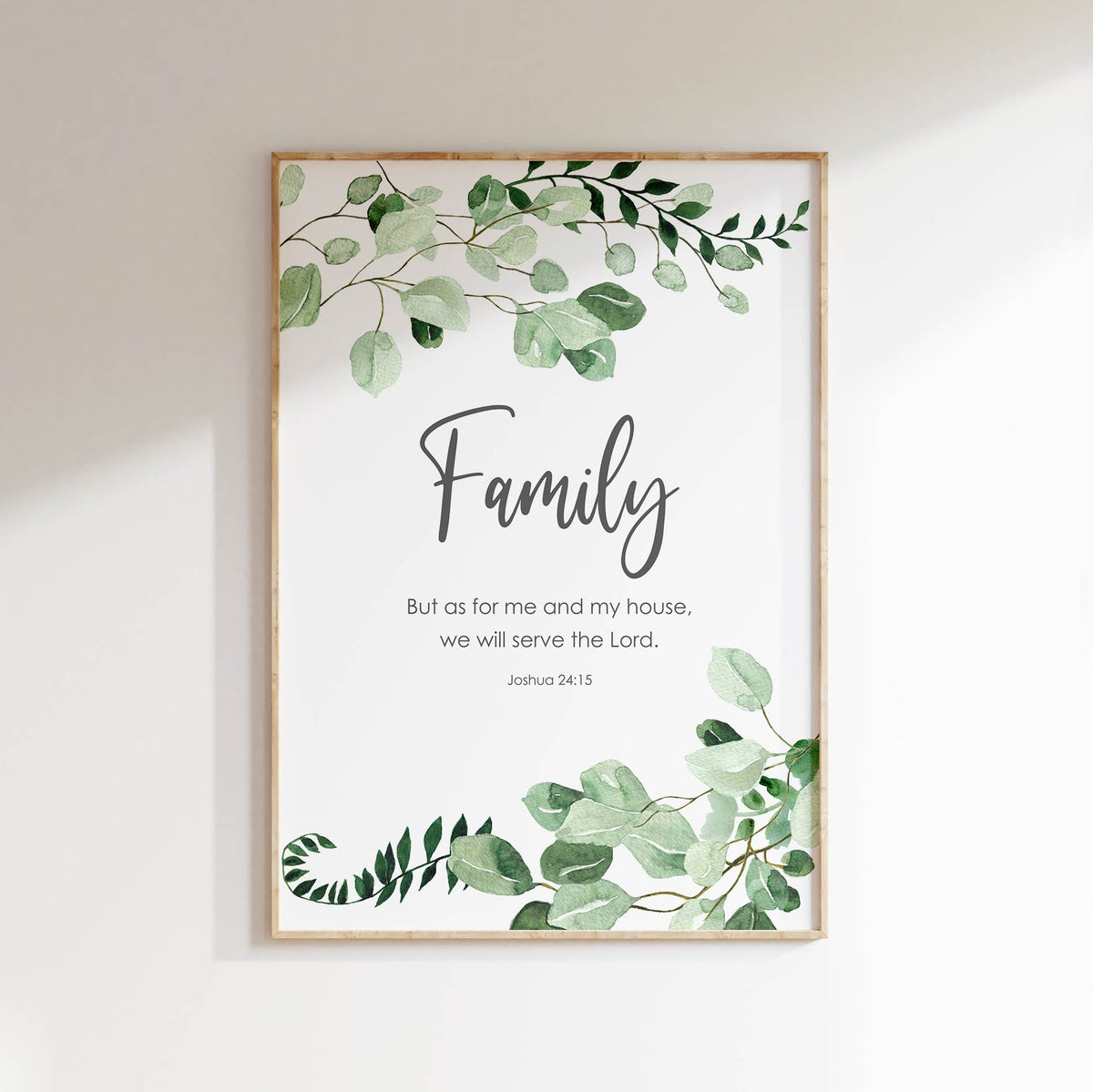 Bible verse wall art with Joshua 24:15, displaying a family faith quote surrounded by soft botanical leaf illustrations.