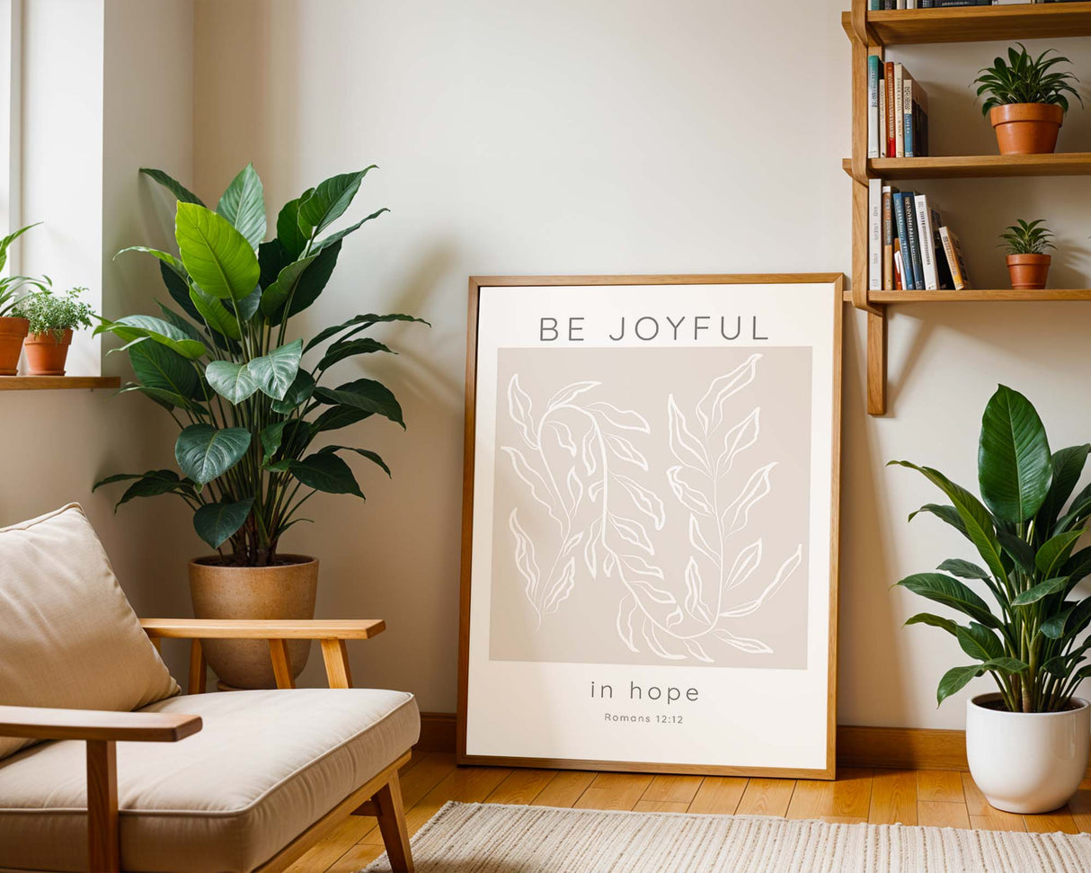 Romans 12:12 – Christian scripture wall art with elegant botanical leaves and calming neutral background.
