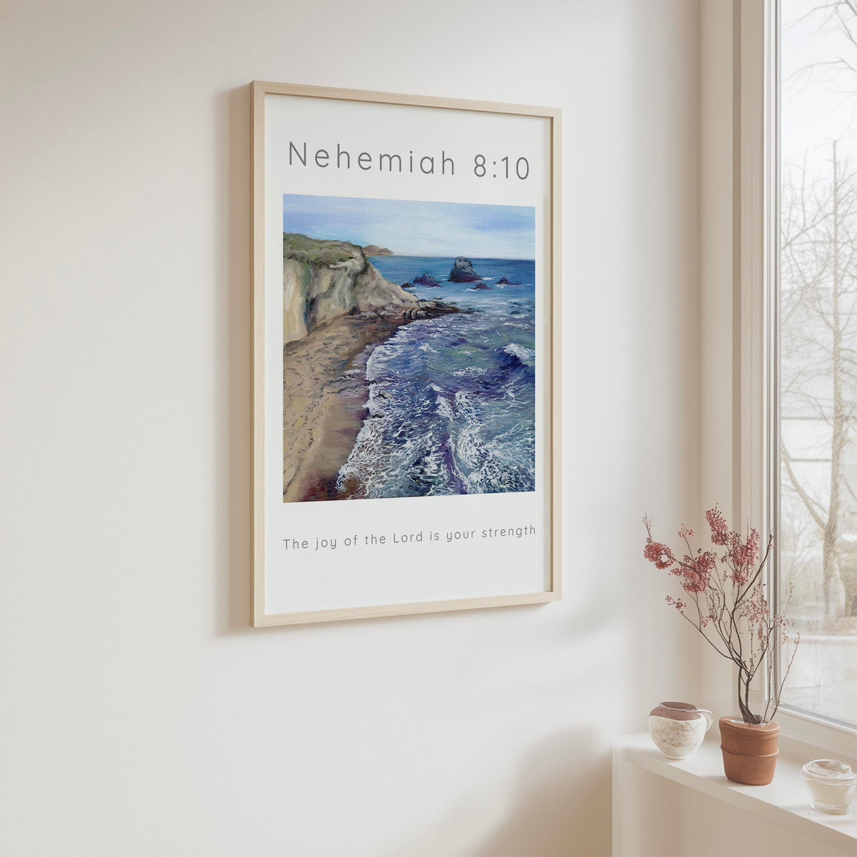 Christian beach wall art featuring Nehemiah 8:10 with blue sea and cliffs on the left, reminding us of God’s strength.