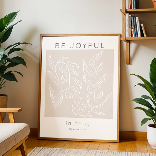 Romans 12:12 – Christian scripture wall art with elegant botanical leaves and calming neutral background.