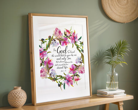 John 3:16 - Scripture wall art with delicate floral wreath and God so loved the world verse in elegant font.
