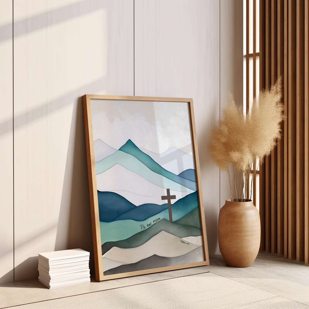 Matthew 28:6 – He Has Risen Christian wall art with blue green mountains and central cross celebrating resurrection hope.