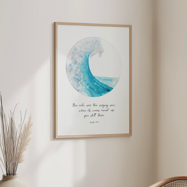 Turquoise ocean wave captured in a circular design with the Bible verse “You rule over the surging sea” from Psalm 89:9, creating a calm and reassuring Christian wall art print.